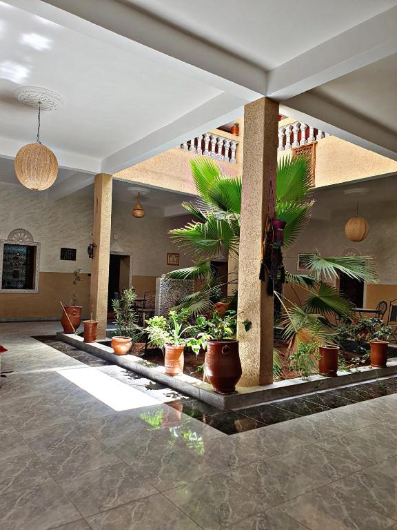 a lobby with potted plants in a building at Riad Tazoulte in Agdz