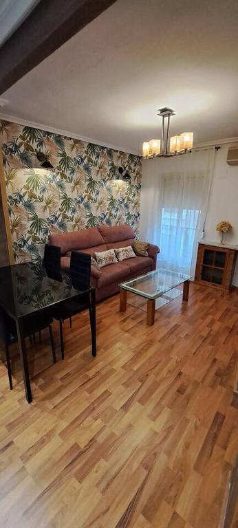 a living room with a couch and a glass table at El Refugio de la Catedral in Jaén