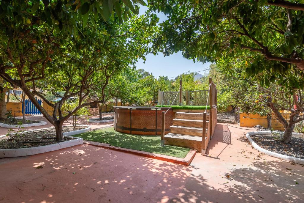 a playground in a park with a swing and trees at Villa Ojuelos Paraíso Natural in Vega de San Mateo