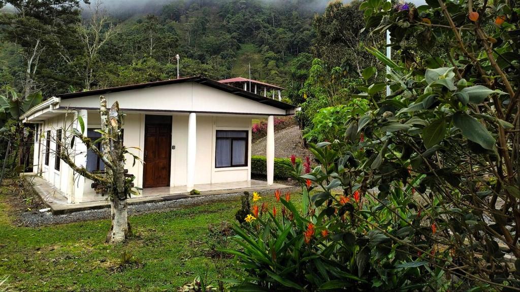 a small house in the middle of a garden at Pacayitas El Camino House in Turrialba