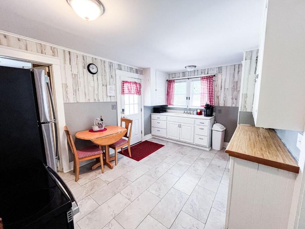 a kitchen with a table and a kitchen with a sink at Walk to Golfcourse EnJoie House PetFriendly in Endicott