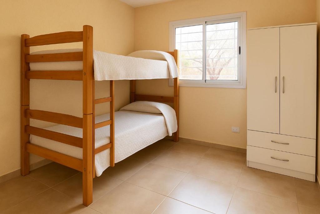 une chambre avec deux lits superposés et une fenêtre dans l'établissement Unquillo Cordoba departamento con parilla, à Unquillo
