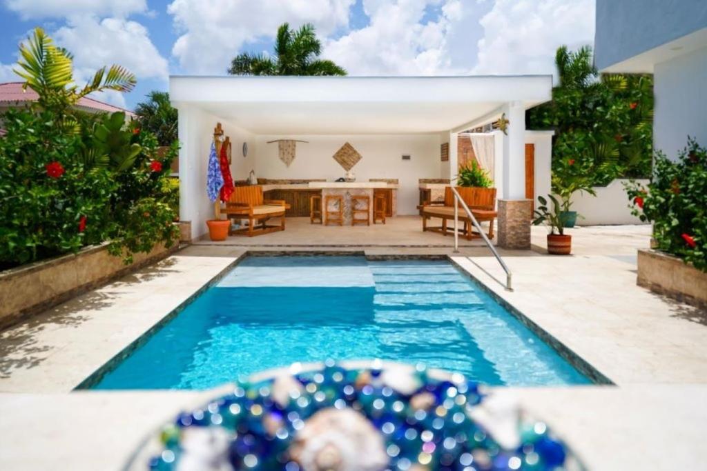 una piscina en un patio con una casa en Tropical Tranquility, en Grote Berg