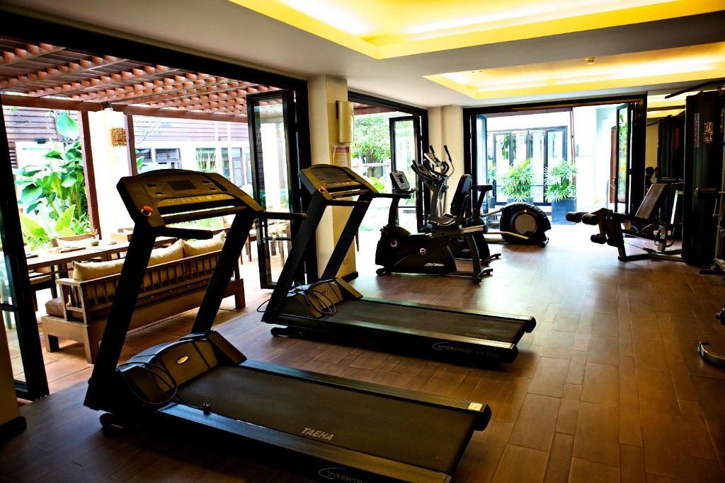 A bright fitness room with treadmills, ellipticals, and other cardio equipment.