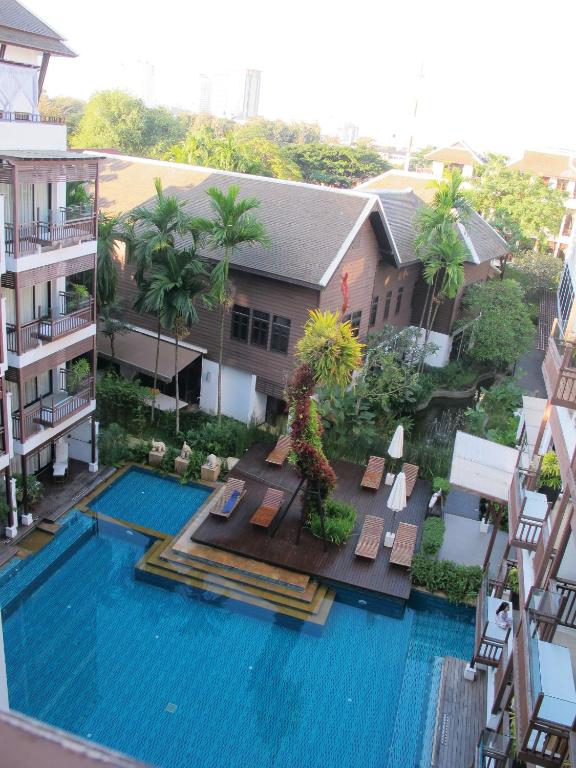 An elevated view over the resort's large blue swimming pool and landscaped grounds.