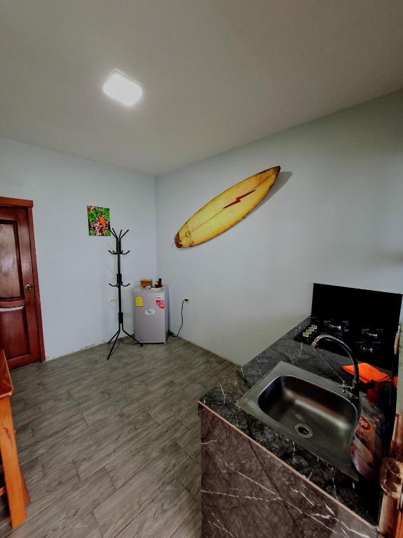 a banana hanging on a wall next to a sink at Casa Scalesia Apartments Galápagos in Puerto Baquerizo Moreno