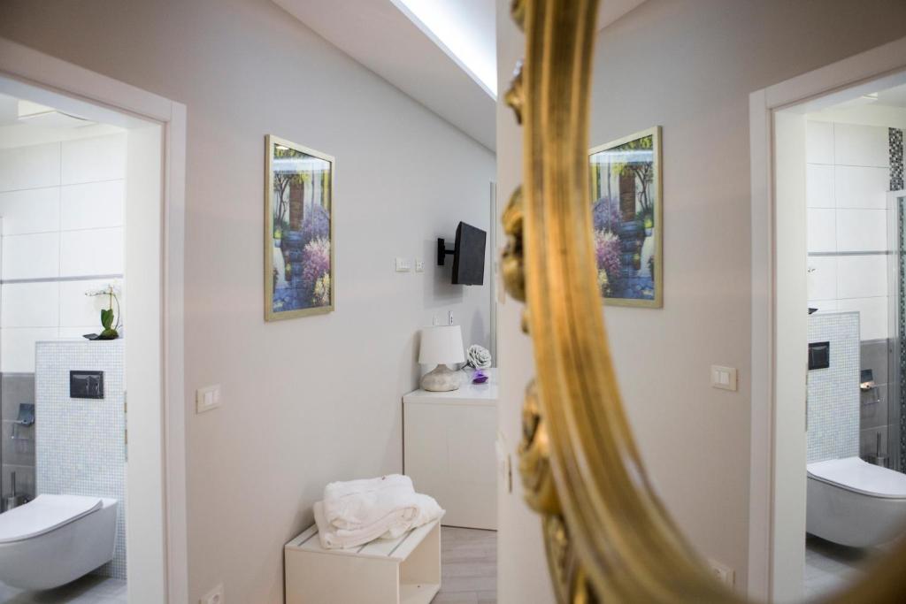 a bathroom with two toilets and a mirror at Boutique Hotel Melissa in Poreč