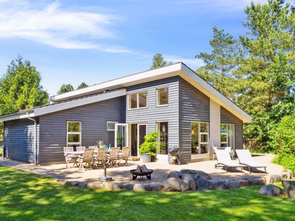 a modular home with a patio and lawn at Holiday Home Romil - 2-1km from the sea by Interhome in Højby