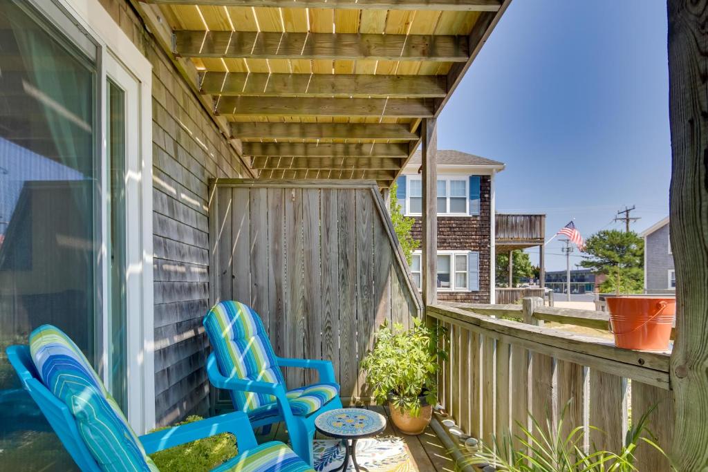 a porch with two blue chairs and a table at Pool and Beach Access Coastal Condo in Provincetown in Provincetown