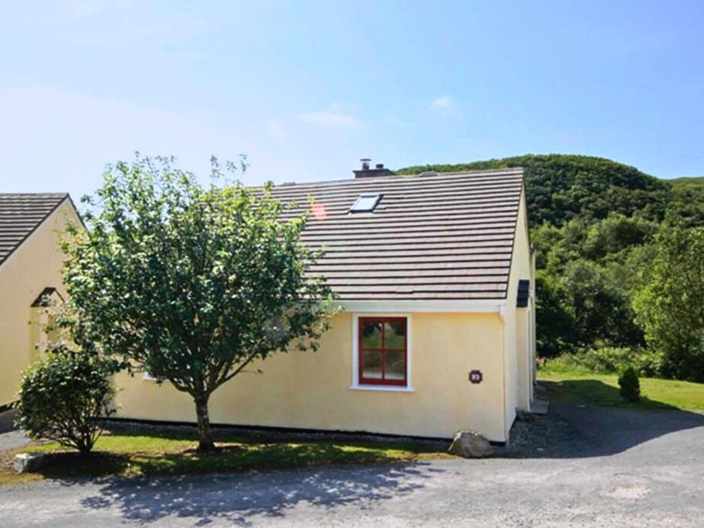 a small house with a tree in front of it at 93 Clifden Glen in Clifden