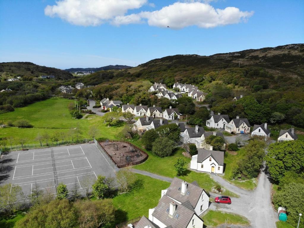 an aerial view of a village with houses and a parking lot at 93 Clifden Glen family friendly cottage in Clifden