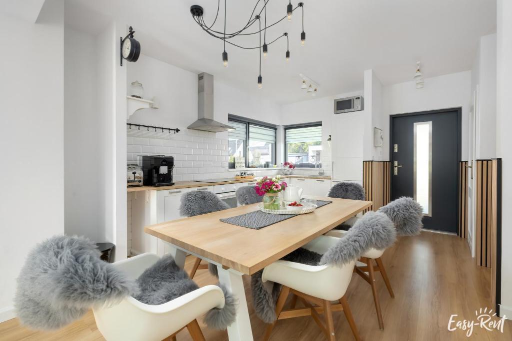 a kitchen and dining room with a wooden table and chairs at Sea Life in Trzęsacz