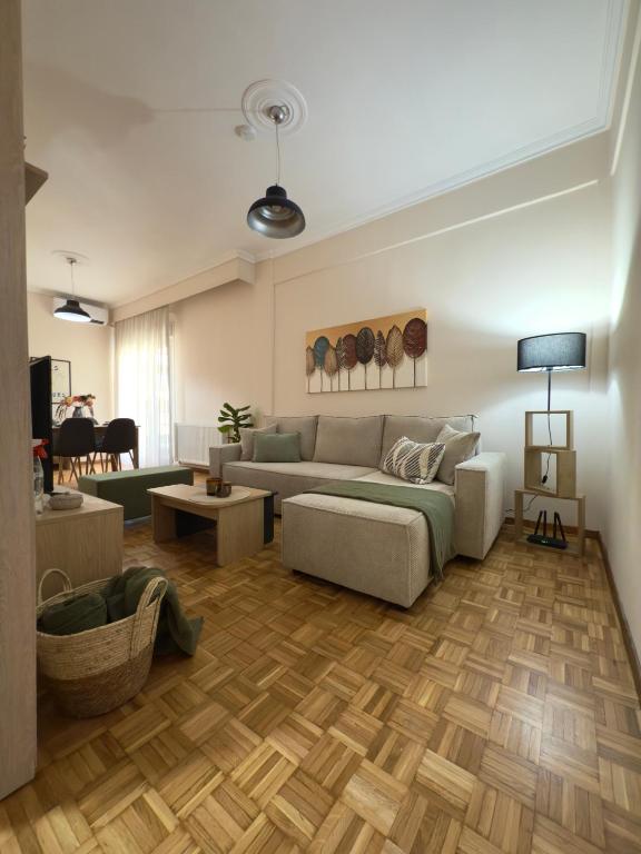 a living room with a couch and a table at Benoikon House With Free Private Parking in Serres