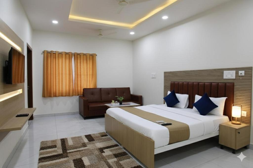 a bedroom with a large bed and a couch at Hotel JK Height's Miyapur, Near Lingampally Railway Station in Lingampalli