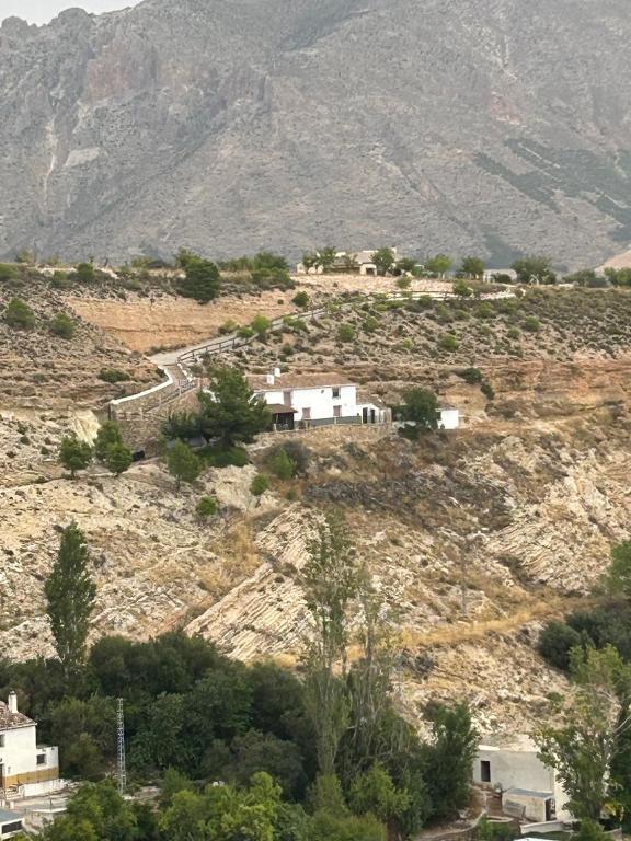 a village on a hill with a mountain at La Cueva in Vélez Blanco