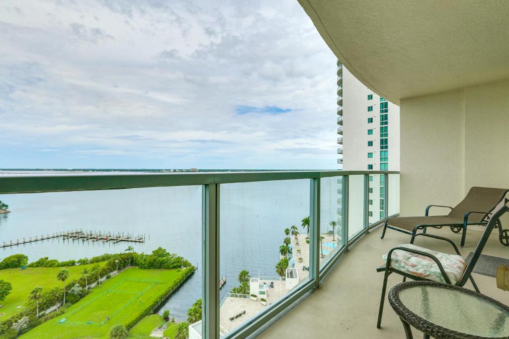 a balcony with chairs and a view of the ocean at Heated Pool Access! Waterfront Fort Myers Condo in Fort Myers