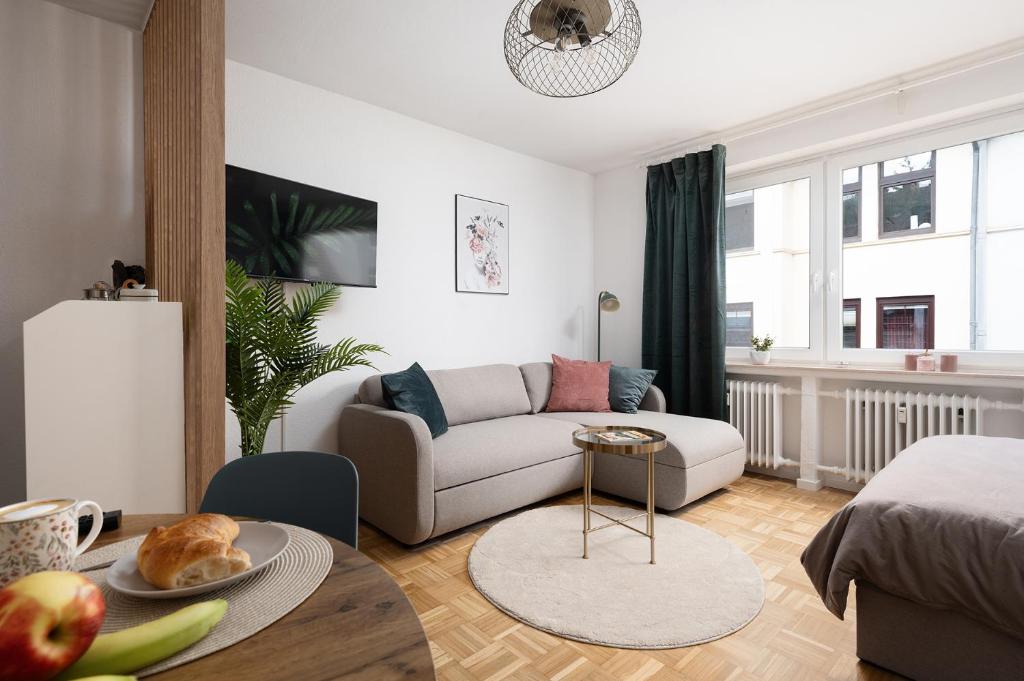 a living room with a couch and a table at MINZ Studios in Bremen