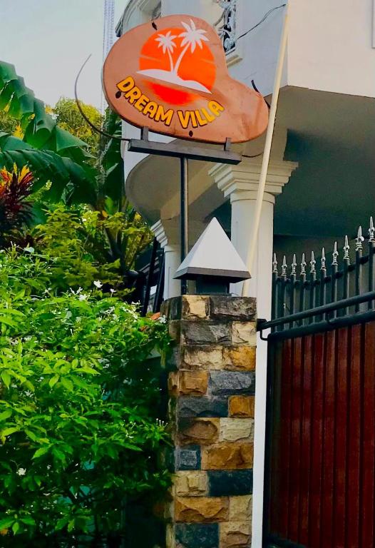 a pizza wing sign on the side of a house at Dream Villa in Batigama