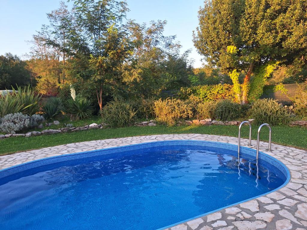 a swimming pool in a yard with a garden at Villa Malini in Grožnjan