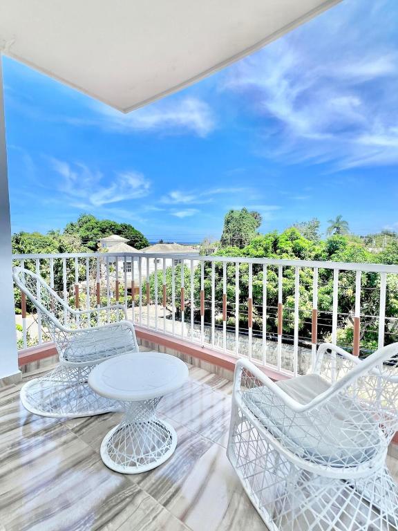 a patio with chairs and a table on a balcony at Beautiful and confortable apt in Puerto Plata