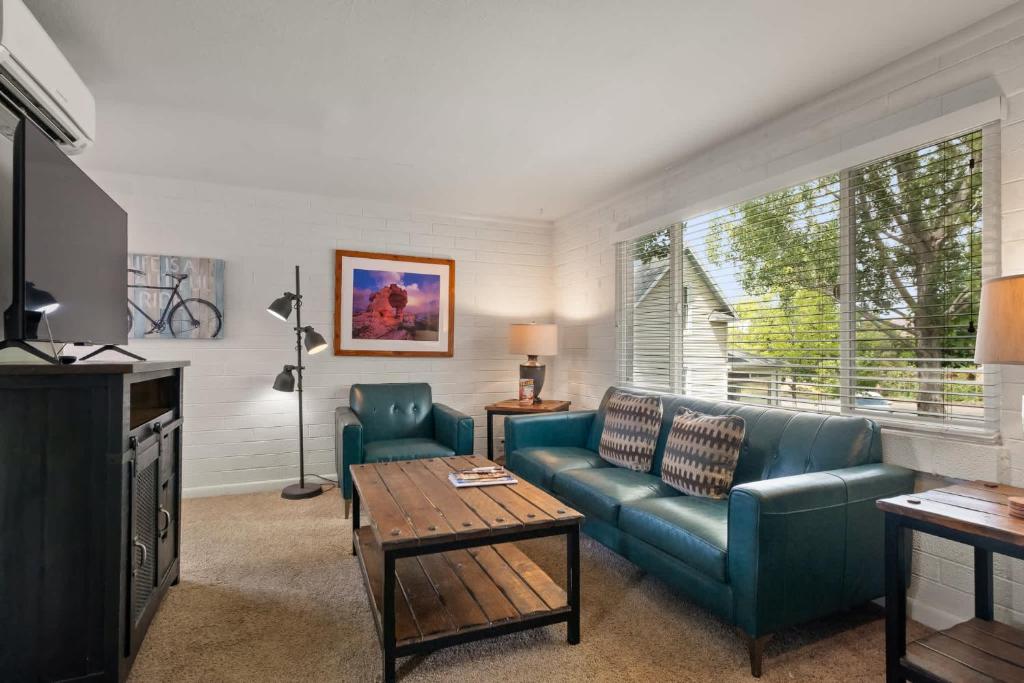 a living room with a couch and a table at Downtown Cozy Home Base - Purple Sage 8 in Moab