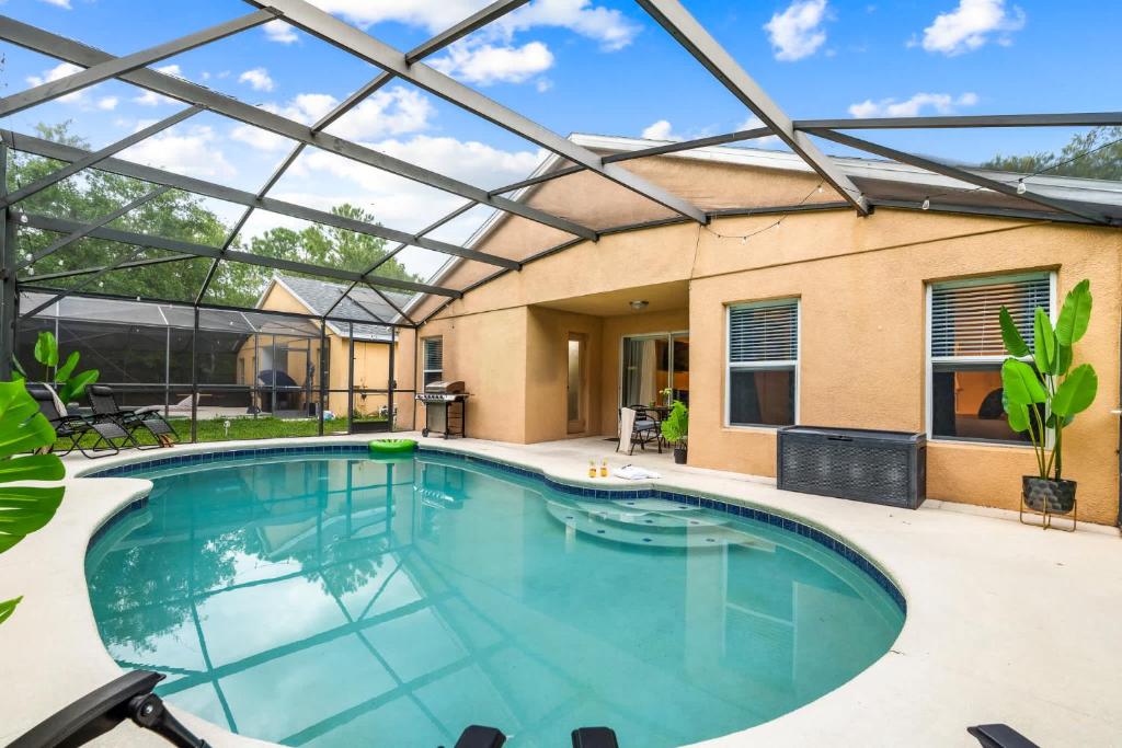 a swimming pool with a glass roof over it at The Sunny - Theme Parks , Heated Pool , Grill in Davenport