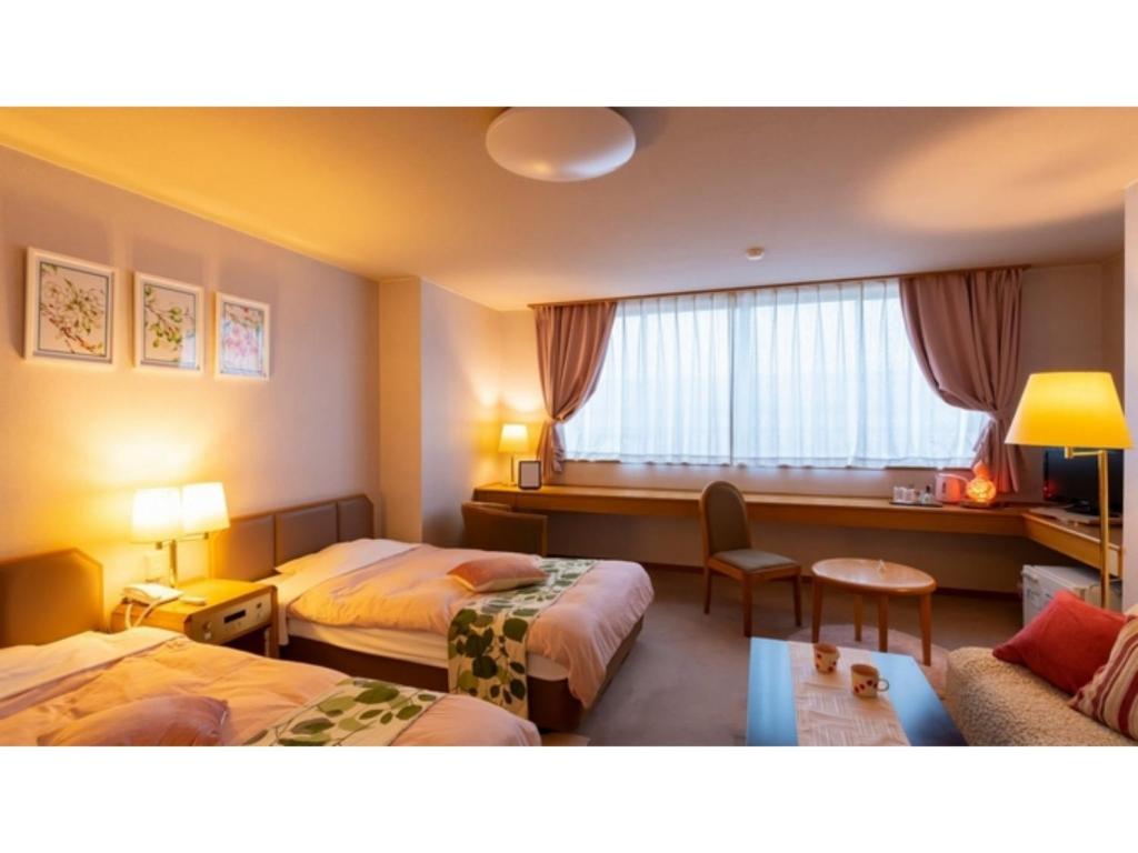 Ένα ή περισσότερα κρεβάτια σε δωμάτιο στο Hotel Symphony - Vacation STAY 37089v