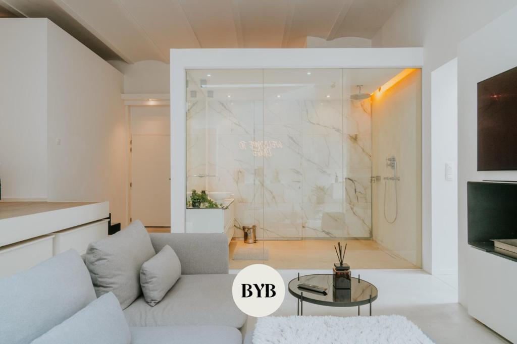 a living room with a couch and a shower at Luxury loft with private parking in Liège