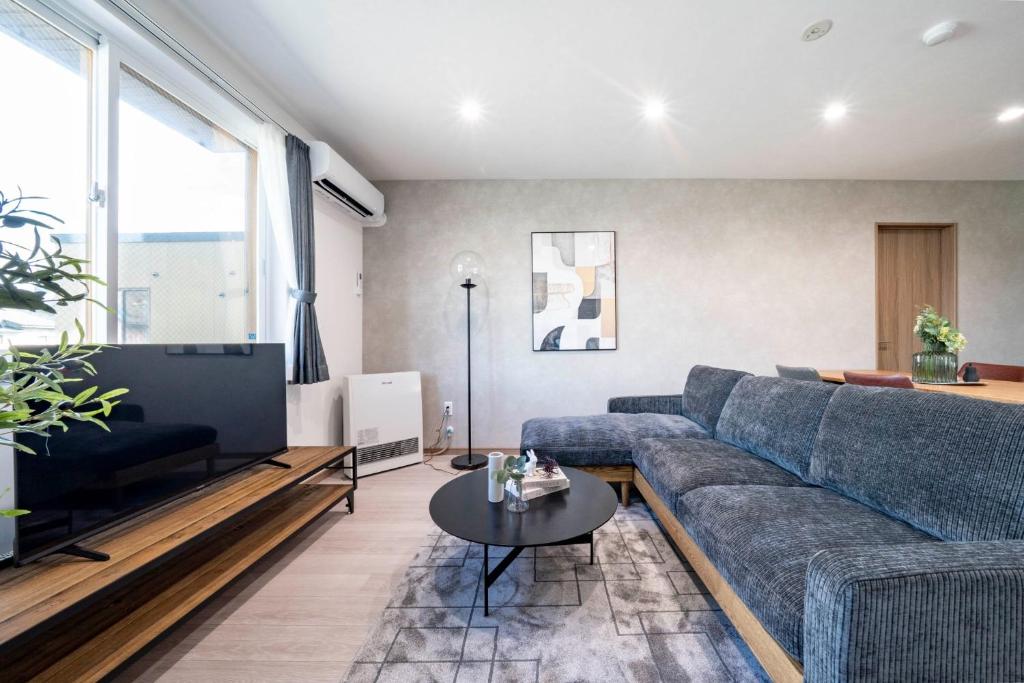 a living room with a blue couch and a table at MKS202 - Vacation STAY 20135 in Gojōdōri