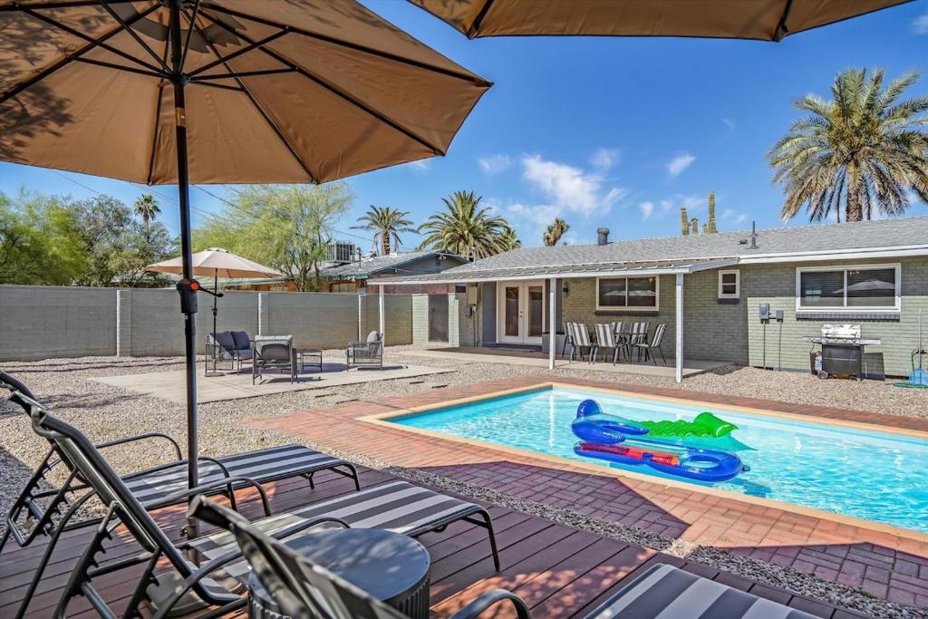 a house with a swimming pool with at Tucson Oasis by Rather Be Properties in Tucson