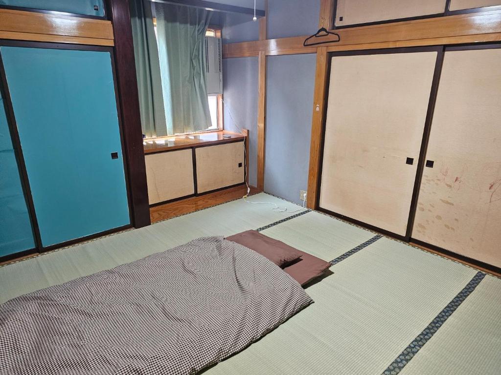 a room with two sliding glass doors and a bed at Mogamigun - House - Vacation STAY 20213 in Shinjo