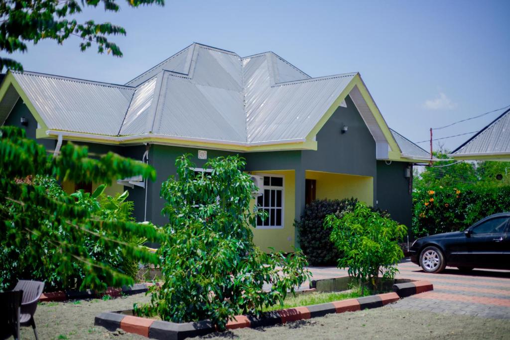 a green house with a metal roof at Antelope homestay in Boma la Ngombe