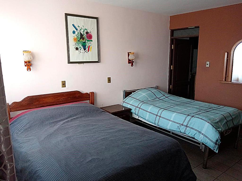 Кровать или кровати в номере La Casa Discreta Cochabamba