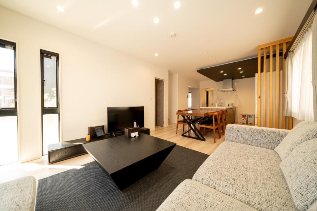 a living room with a couch and a table at Ume no Yu Moonlight - Vacation STAY 42183v in Dazaifu