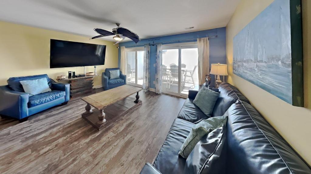 a living room with a couch and a tv at Put-in-Bay Waterfront Condo #208 in Put-in-Bay