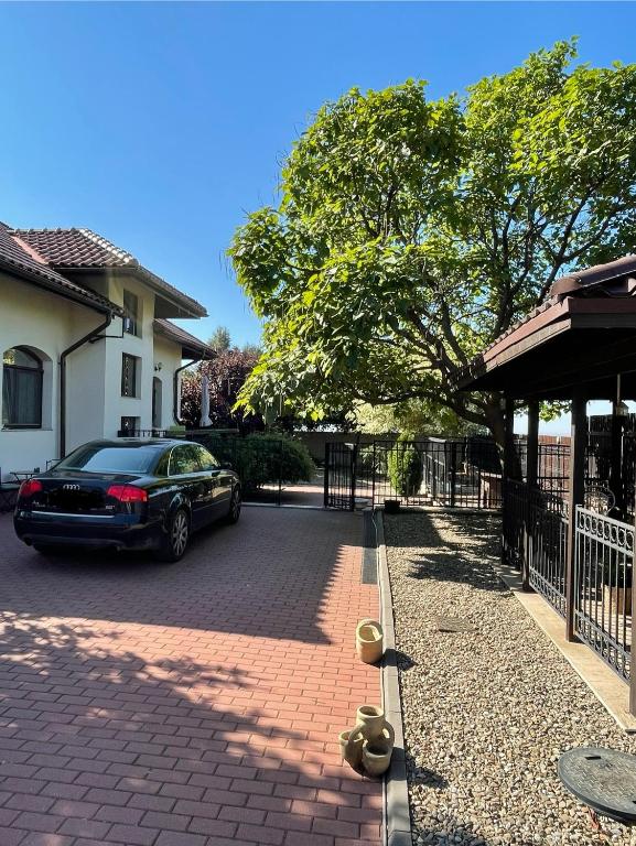 a car parked on a brick driveway in front of a house at Le Bon Choix in Tohani