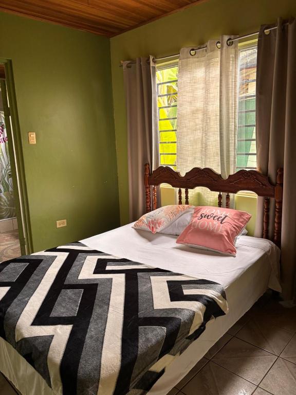 a bed with two pillows on it in a bedroom at Alma Delfina in San Isidro de El General