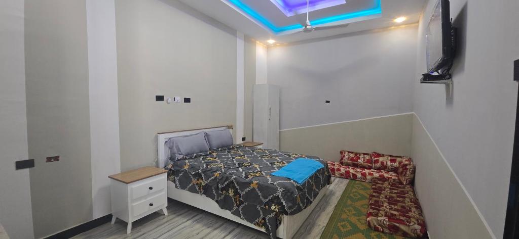 a small bedroom with a bed and a desk at Arhiba Guest House አርሂባ እንግዳ ማረፊያ 