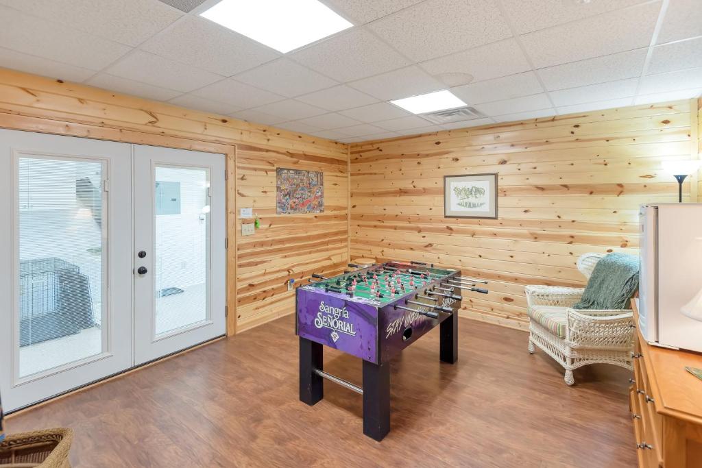 a game room with a foosball table in the center at Lazy Dog Log Cabin, Hot Tub, Fishing Lake, New River Access, Foosball in Wagoner