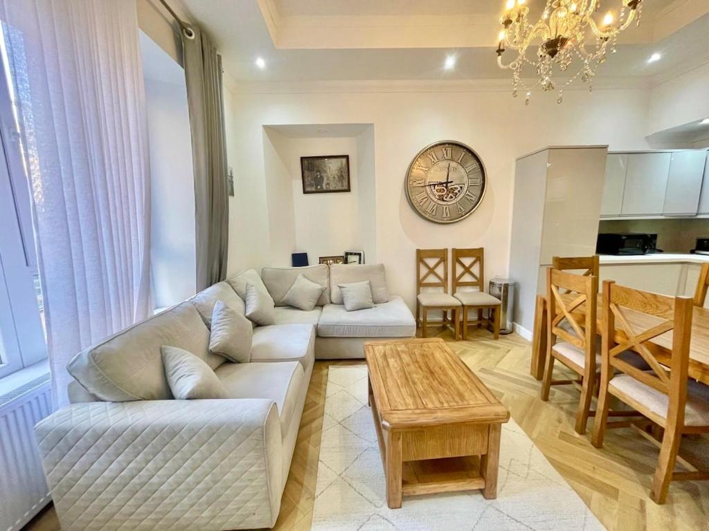 a living room with a couch and a table at Three bedroom Apartment In Glasgow City Centre in Glasgow