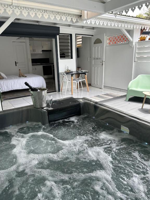 a pool of water in the middle of a patio at Obuncoeur avec spa in Le Gosier