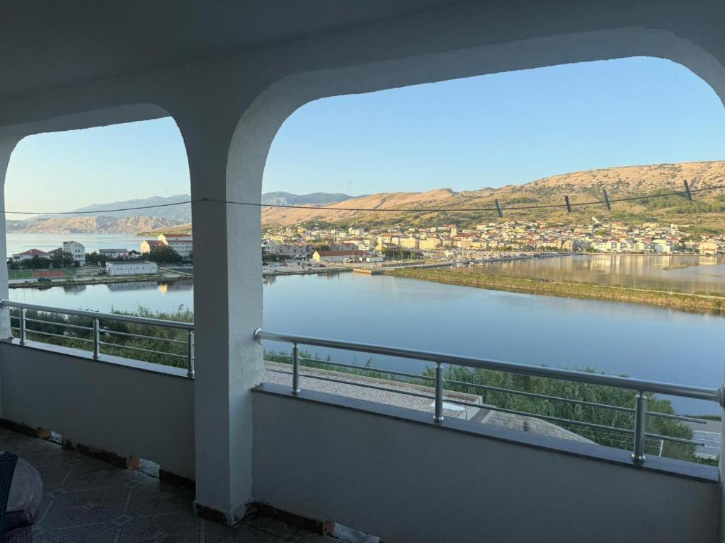 a view of a river from a building with two windows at Apartments Anđelka in Pag