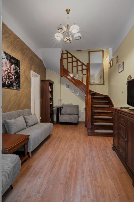 a living room with a staircase and a couch at Interbelic Villa near Old Town in Bucharest