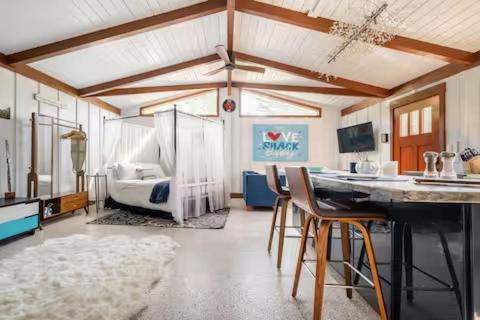 a room with a bedroom with a bed and chairs at The Love Shack in Carmel