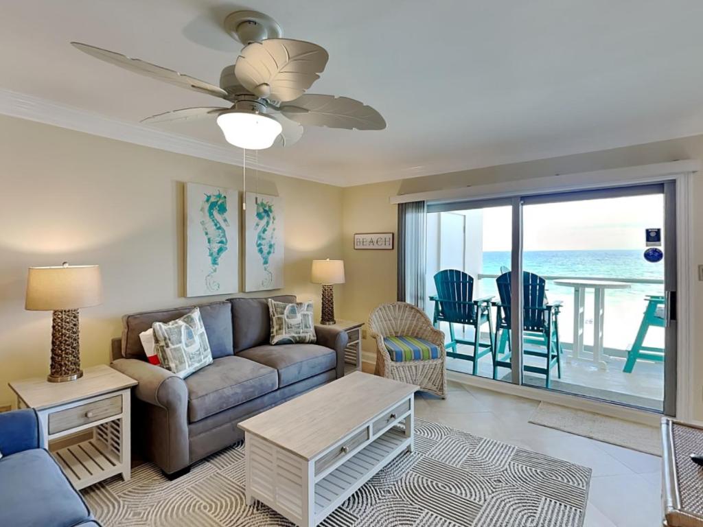 a living room with a couch and a table at Regency Towers #505 West in Oriole Beach
