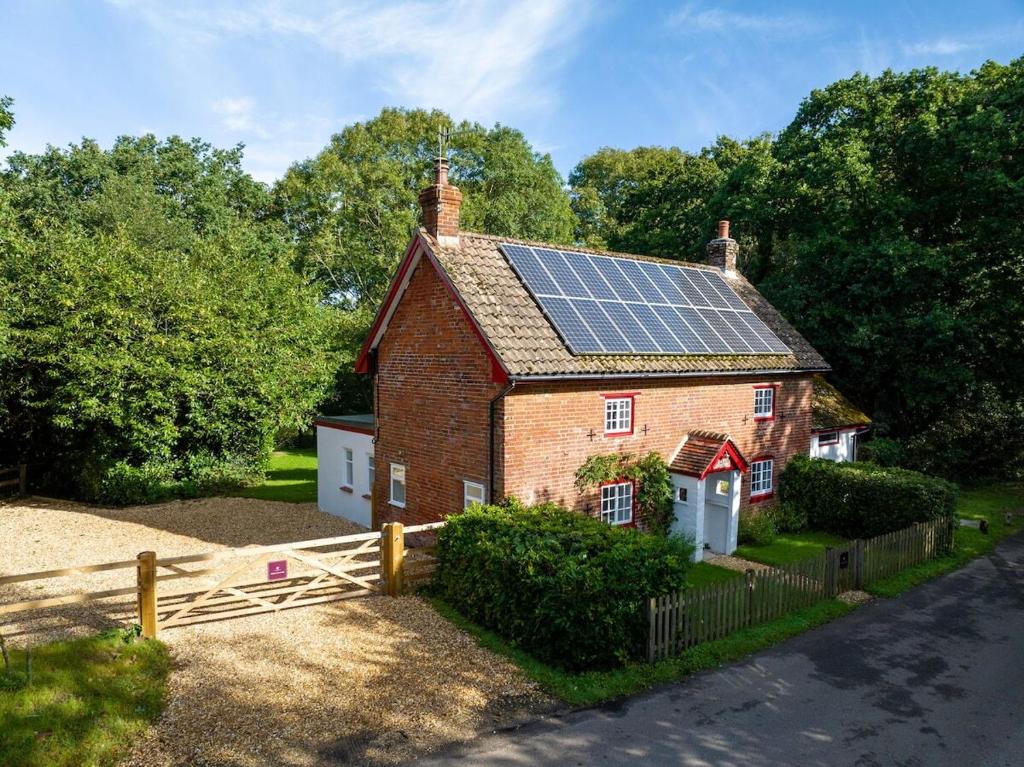a house with solar panels on the roof at Ames Cottage in Hinton
