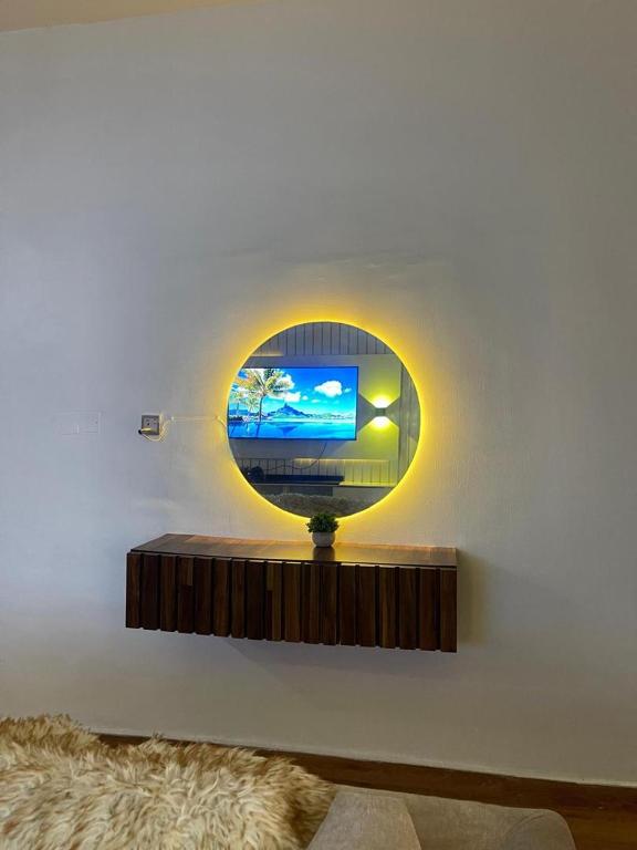 a living room with a tv on a wall at MBA Lux & suites in Maiyegun