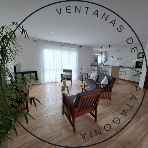 a large living room with chairs and a mirror at Ventanas de la Patagonia in Esquel
