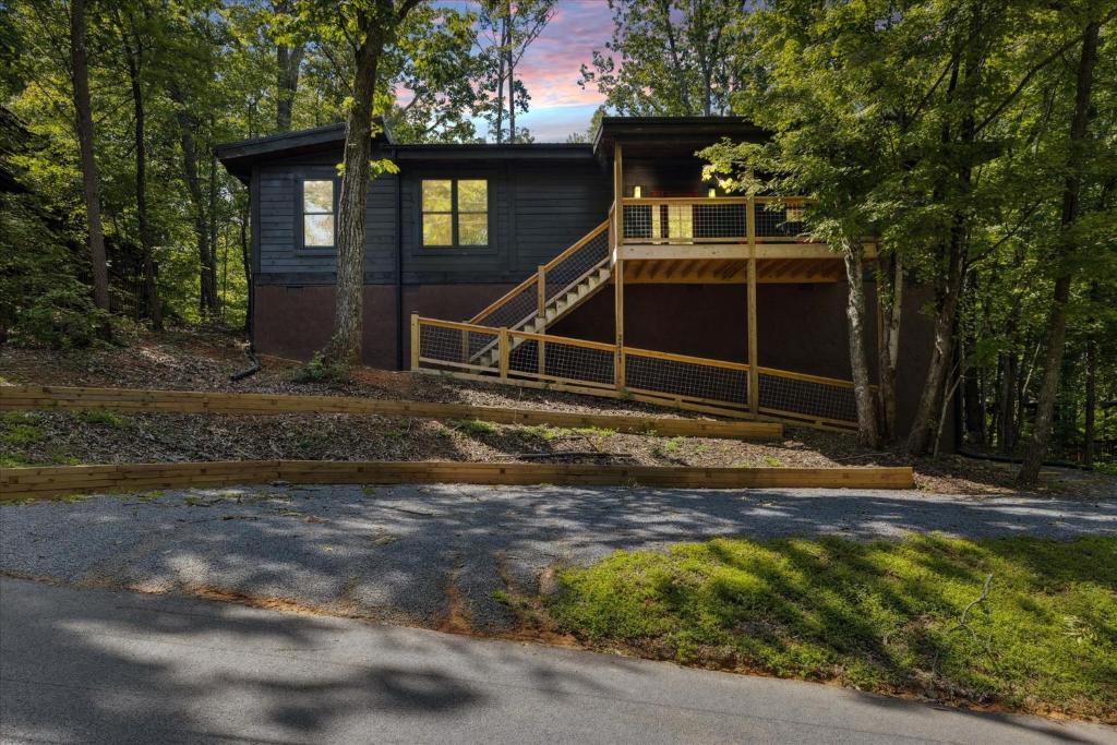a house in the woods with a porch at Bearodise By Beyond Expectations W Hot Tub in Glade