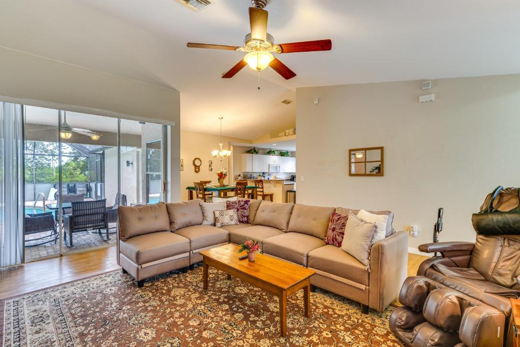 a living room with a couch and a table at Family Home with Pet-Friendly Yard in Fort Myers! in Lehigh Acres